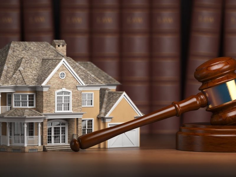 House with gavel and law books.  Real estate law and house auction concept. 3d illustration